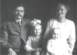 black and white photo of family with mother and father and two children